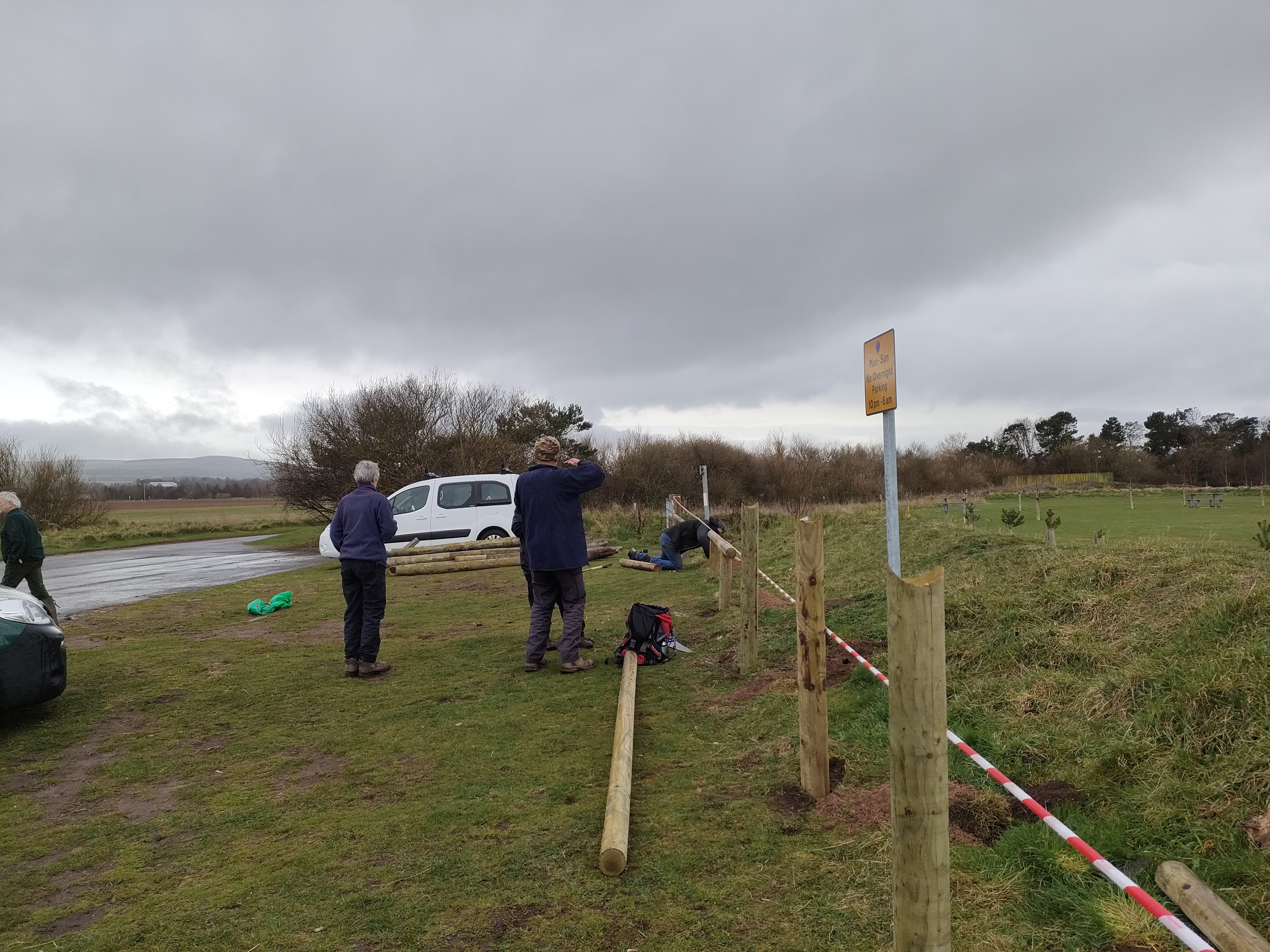 People building a low fence.